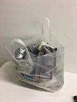 Photo of plastic bag filled with multiple packs of plastic sports card protectors.