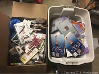 Two storage bins filled with various unopened packages of women's hosiery in assorted styles and colors.