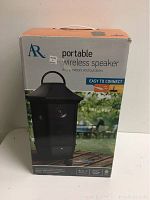 Front view of boxed AR portable wireless speaker, black lantern-style design, labeled for indoor and outdoor use with Bluetooth technology and easy connect feature.