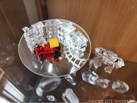 Photo showing the red and yellow crystal train engine with three clear crystal train cars and clear crystal frog.