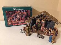 Photo showing entire nativity set including stable and all figurines, with box in background