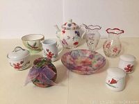 Photo of the 11-item set including the Braum Bros teapot, glass vases, ceramic jars, mugs, bowls, and floral container
