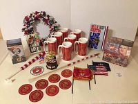 Photo showing Marine collection including cups, coasters, flags, wreath, musical box, books, and memorabilia arranged on table