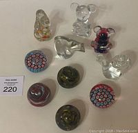 Nine glass animal figurines and decorative shapes including bears and paperweights