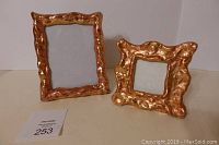 Both copper frames shown side by side on a plain surface with white background