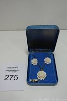 Full view of the white flower necklace and matching earrings displayed in a blue presentation box with seller lot number card.