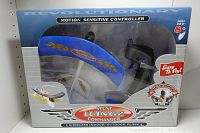Front of the boxed Stunt Wingz Commander plane showing blue wing with flame graphics, the plane's propeller, and controller visible through window.