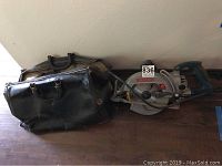 Photo showing Bosch circular saw, black carrying case and another fabric case