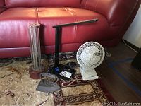 All four items together on carpet: vintage glass lamp, OttLite desk lamp, Coolmaster desktop fan, antique SAD iron