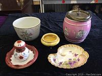 Full lot view showing all five porcelain items on black cloth background.
