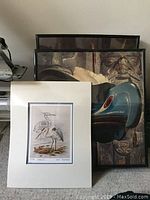 Group photo showing several Aboriginal prints, including framed and matted pieces with Indigenous Northwest Coast designs and animals.