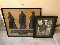 Framed English brass rubbing and framed woodcut print next to each other on floor showing complete lot