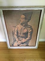 Framed Picasso reproduction painting on board depicting seated figure in costume