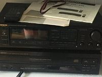 Onkyo R1 tuner/amplifier on top with Denon DCM-340 CD changer below, showing controls and model labels
