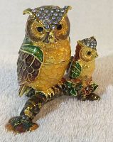 Front view of metal owl trinket box showing two owls decorated with colorful enamel and rhinestones.