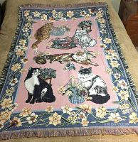 Full view of the cotton throw showing six different cats in various poses with floral borders and fringe edges.