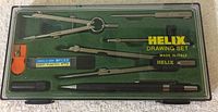 Top-down image of the complete Helix drawing set showing compass, pencil, divider, leads, eraser, and case interior.