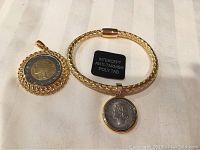 Photo showing bracelet with coin centerpiece and pendant with coin centerpiece with Intercept anti-tarnish poly tab next to them