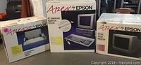 Original boxes of Apex PC computer system, color monitor, and printer placed next to each other showing branding and equipment images.