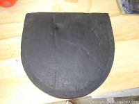 Single photo showing a semi-circular black foam pad with signs of wear and use