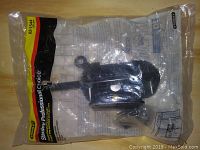 Original sealed clear bag holding Stanley Professional gate latch and mounting hardware with label and branding visible.