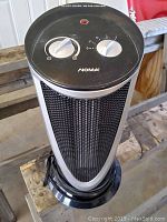 Top view of NOMA tower fan showing its two rotary dials and red indicator light.