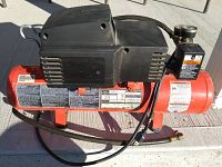 Side view of the PRO Air II electric air compressor showing the tank, motor, pressure gauge, and cord.