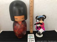 Photo showing both the wood Oriental doll and the Blossom doll with ruler for scale, identifying sizing and details.