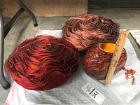 Photo showing two rose-shaped pillows, the art glass vase, and the frog figurine with a ruler for scale.