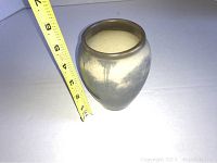 Photo showing size measurement with tape near vase to confirm approx 5 inches height.