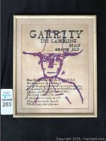 Front view of framed silk screen broadside showing text and purple abstract portrait on beige background with aged frame and visible scuffs