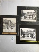 Photo showing all three prints together; two plantation house prints with columns, one streetcar print on city street; two still in clear wrap.