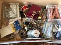 Drawer filled with assorted jewelry making supplies including beads, wires, clasps, and new costume jewelry sets