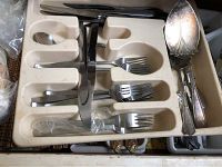 Oxford silver-plated flatware including forks and serving spoons with decorative handles, organized in compartmental tray.