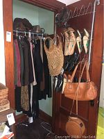 Full closet with jackets on hanging rod, shoes on over-door shoe rack, and purses hanging from hooks on door.