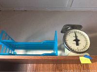 Vintage Taylor kitchen scale in cream color with metal weighing tray and large circular dial.