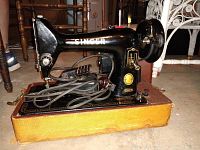 Full view of the Singer 99K sewing machine mounted on its case with power cord.
