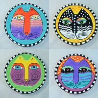 Shows full set of 4 Laurel Burch styled cat plates with various colorful cat face designs and checkered borders