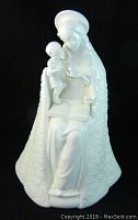 Front view of white porcelain Flower Madonna and Child figurine showing seated Madonna with child on lap holding small flower.