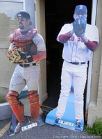 Curt Schilling and Jason Varitek life-sized cutouts standing outside a door, showing full body height and posing details.