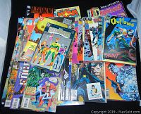 Top view of the entire comic books lot showing a mixed stack of Marvel and DC comic books including Nightwing, Outlaws, Outsiders, Outcasts, Nova, and Plastic Forks graphic novels