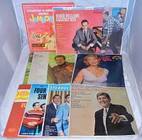 Photo showing the front covers of nine vintage LP records from the 1950s and 1960s, including artists Roger Williams, Dinah Shore, The Ames Brothers, and Wayne Newton.