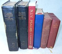 Six religious books aligned side by side, titles visible including "Missel Quotidien Des Fidèles," "N.T.V. Psalms," and "La Sainte Bible."