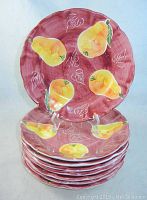 Stack of 8 bowl plates showing pear design and size.