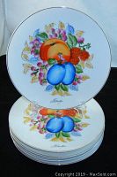 Stack of five white ceramic plates each hand-painted with colorful fruit design including peaches, plums, and berries, signed "Takeshi." Plates are approximately 8 inches in diameter and appear in mint condition.