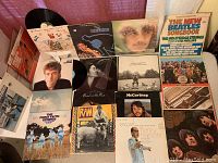 Vinyl LPs showing front covers of John Lennon, Paul McCartney solo albums, Beatles albums, and other associated artist collections.