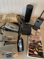 Photo of the Radio Shack intercom units, GE transceiver, Alexa speaker and Scanner Master book together.