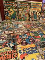 Several Captain America comic books laid out showing colorful vintage covers mostly from the Marvel Comics Group, featuring Captain America and The Falcon.