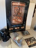 The lot items displayed together showing Darth Vader mask, special edition movie program, sealed movie poster, and puzzle.