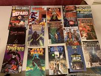 Photo showing all 15 comic books laid out on a flat surface, displaying front colorful illustrated covers including multiple Star Wars issues and other notable comics.